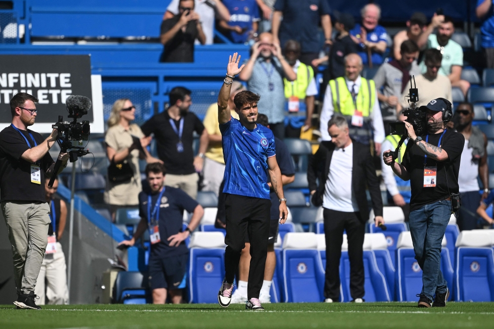 Chelsea's new signing Portuguese midfielder Pedro   Neto waves to the fans at half-time, in the pre-season friendly football match between Chelsea and Inter Milan at the Stamford Bridge stadium in London on August 11, 2024. — AFP pic