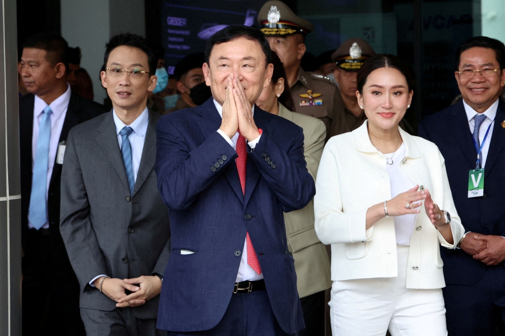 Former Thai PM Thaksin Shinawatra seen here with his son Panthongtae Shinawatra and daughter Paetongtarn Shinawatra at Don Mueang airport in Bangkok in this file photo taken on August 22, 2023. ― Reuters pic