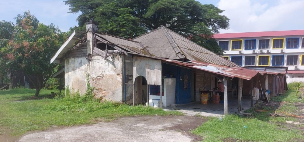 The semi-detached wooden house in Silibin, Ipoh, where K. Elangovathi operates her traditional dhobi business. — Picture by Sylvia Looi