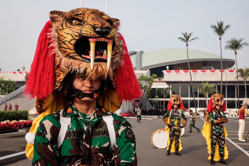 Members of the Indonesian Defence University brass band wait to perfrom before the annual session of the People's Consultative Assembly (MPR) at the parliament building in Jakarta on August 16, 2024. — AFP pic