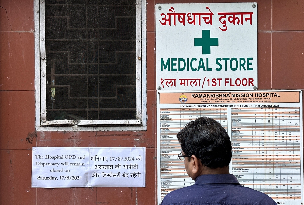 A man reads a notice at the entrance of a hospital in Mumbai, stating that the hospital OPD and dispensary are shut today after a nationwide strike was declared by the Indian Medical Association to protest the rape and murder of a trainee medic at a government-run hospital in Kolkata August 17, 2024. — Reuters pic  