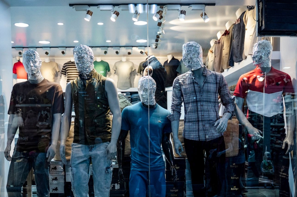 Faceless mannequins with heads wrapped plastic, foil or black bags show off clothes in Afghanistan