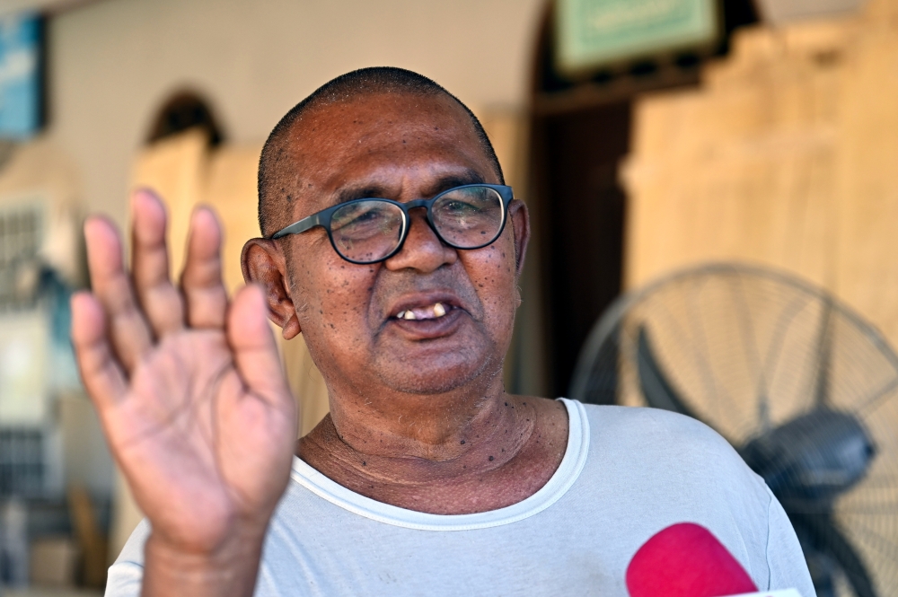 Possessing carpentry skills after decades of being a builder, Omar Mohamed, 68, now spends his time making coffins to be given out for free. — Bernama pic