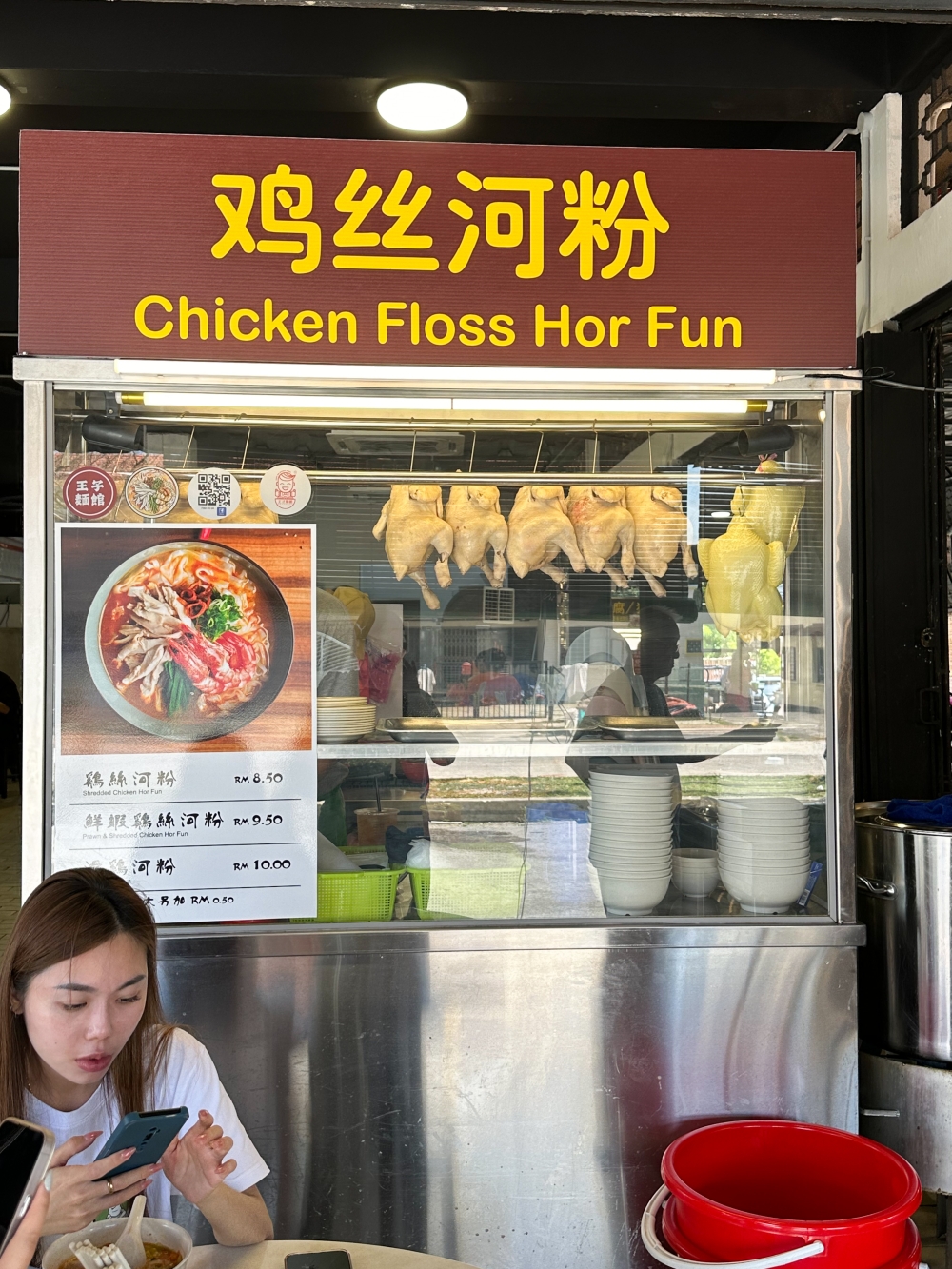 Devoted fans look for clues like this iconic picture of ‘kai si hor fun' and stickers with Wong Zhi Noodle House' name to confirm that this is the same 'kai si hor fun’ they enjoy — Picture by Lee Khang Yi