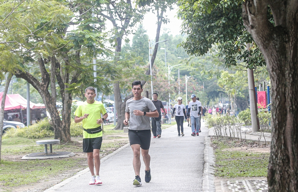 People exercising with their families at the Sultan Abdul Aziz Recreation Park in Ipoh. Keeping active is not just good for the body but also the mind. — Picture by Farhan Najib