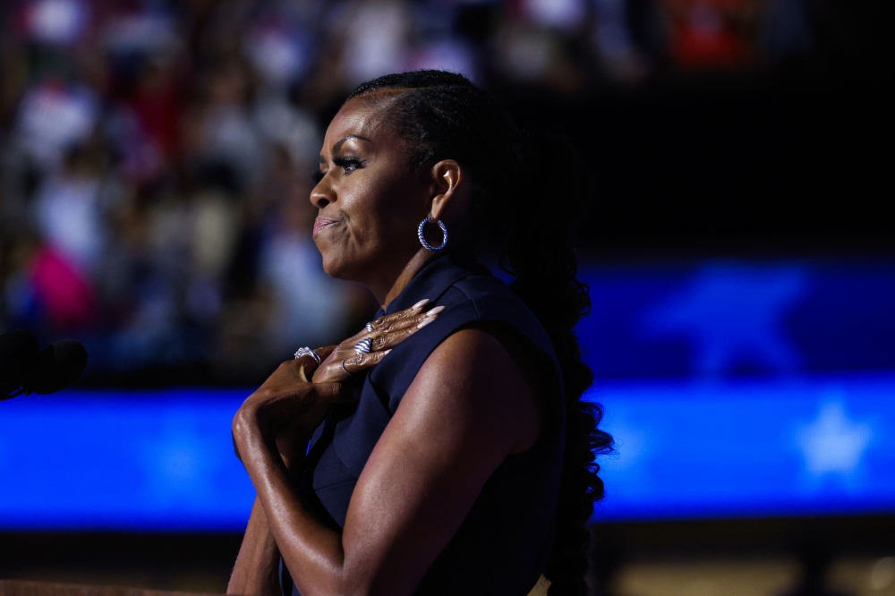 Former first lady of the United States Michelle Obama gestures during Day 2 of the Democratic National Convention (DNC) in Chicago, Illinois August 20, 2024. — Reuters pic  