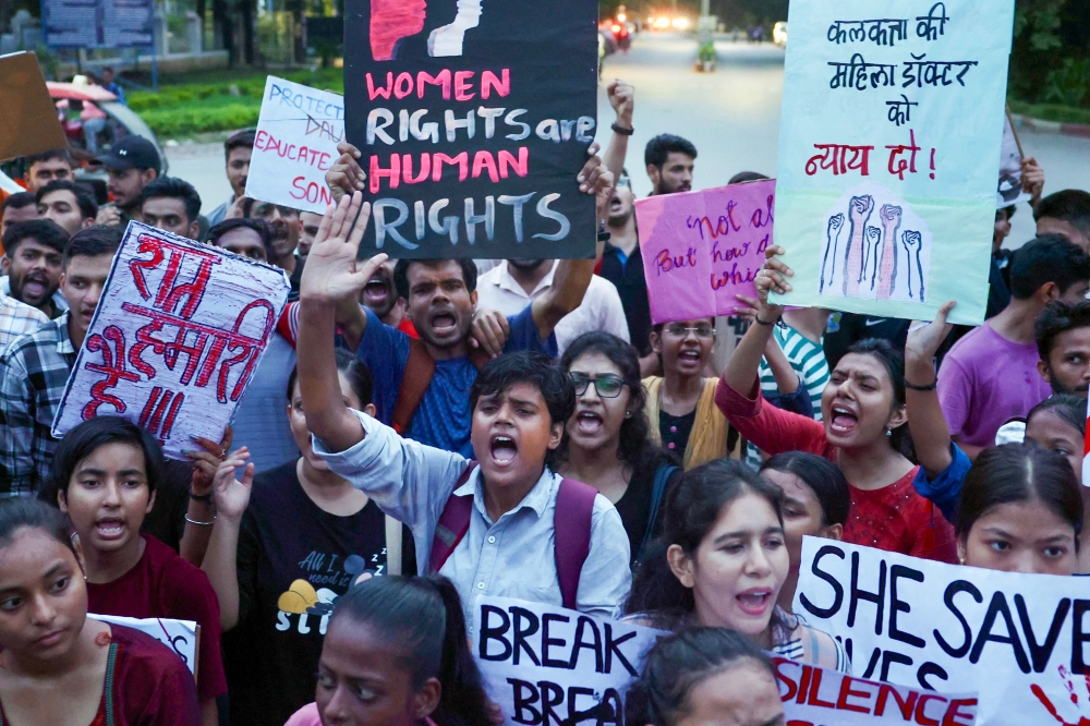 BHU (Banaras Hindu University) students hold posters and shout slogans during a march in Varanasi on August 20, 2024, amid nationwide strike by medical practitioners to condemn the rape and murder of a doctor in India's West Bengal state. — AFP pic