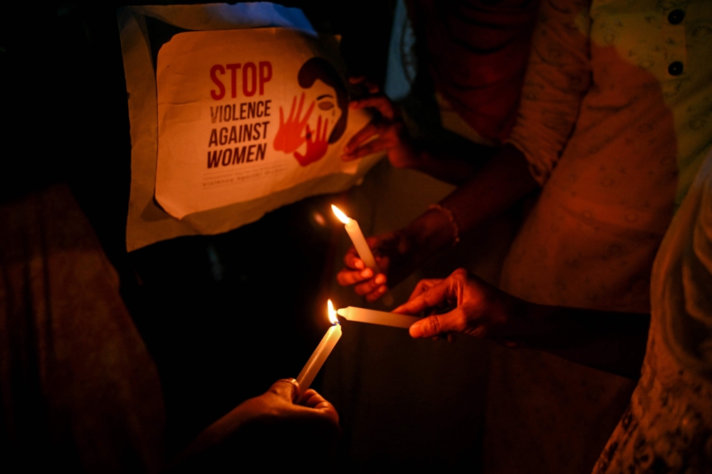 Medical practitioners hold posters during a candlelight march in Chennai on August 20, 2024, amid nationwide strike to condemn the rape and murder of a doctor in India's West Bengal state. — AFP pic