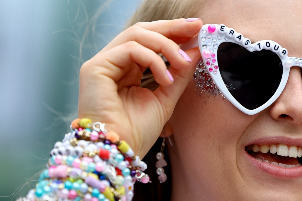 A fan wearing Taylor Swift sunglasses reacts ahead of her concert, following the cancellation of three Taylor Swift concerts in Vienna because of a planned attack, at Wembley Stadium in London August 15, 2024. — Reuters pic  