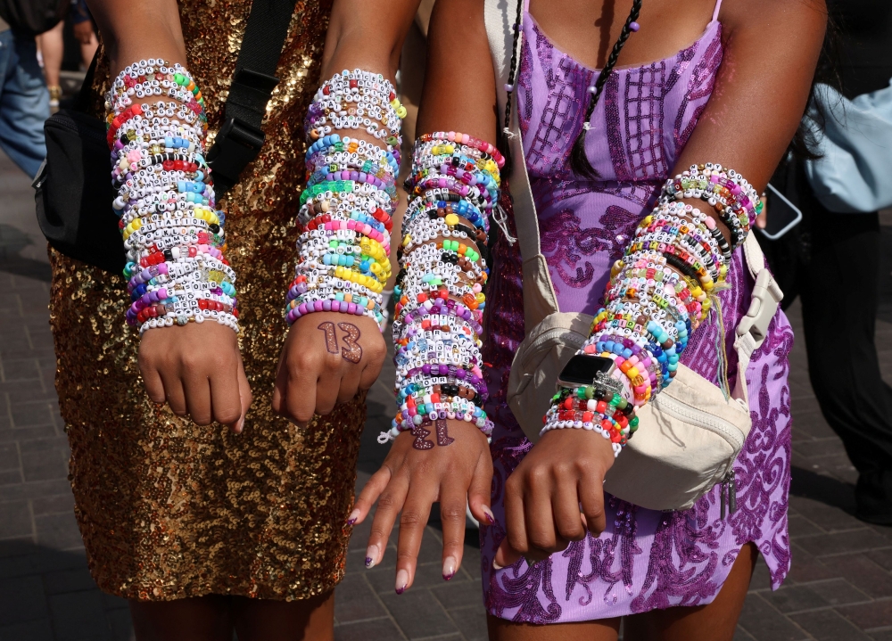 Fans show their Taylor Swift bracelets ahead of her concert, following the cancellation of three Taylor Swift Concerts in Vienna because of a planned attack, outside Wembley Stadium in London August 15, 2024. — Reuters pic