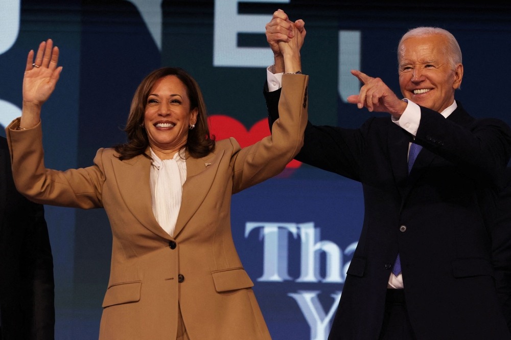 US President Joe Biden and Democratic presidential candidate and US Vice President Kamala Harris gesture during Day one of the Democratic National Convention (DNC) in Chicago, Illinois  August 19, 2024. — Reuters pic  