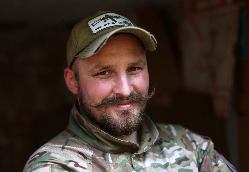 Ukrainian serviceman and influencer Ruslan Mokrytskyi poses for a portrait in an undisclosed location in the Donetsk region July 25, 2024. ‘After missions, there were, let's say... many horrible and stressful images,’ he said. ‘I needed to recuperate mentally.’ — AFP pic