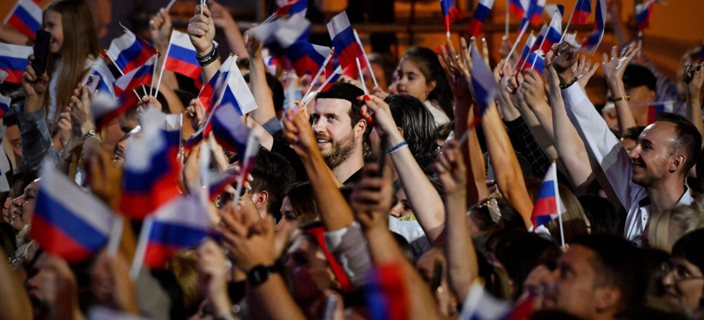 People waves Russian flags during pro-Kremlin Russian pop idol Shaman's (Yaroslav Dronov) concert on Red Square on Flag Day in Moscow August 22, 2024. — AFP pic