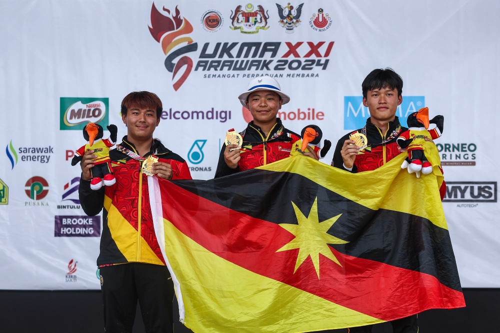 The Sarawak archery trio celebrated success after winning the Men's Team Recurve final against the Pahang team at the 2024 Malaysian Games (Sukma) at the Archery Range, Petra Jaya August 23, 2024. — Bernama pic