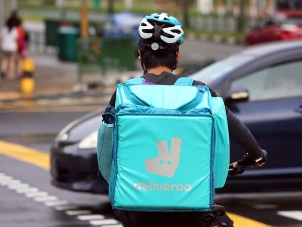 A Deliveroo rider making deliveries.