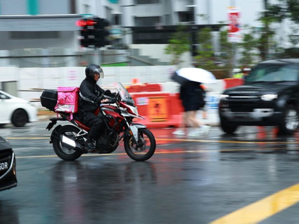 Rain or shine, the food delivery rider keeps on going.