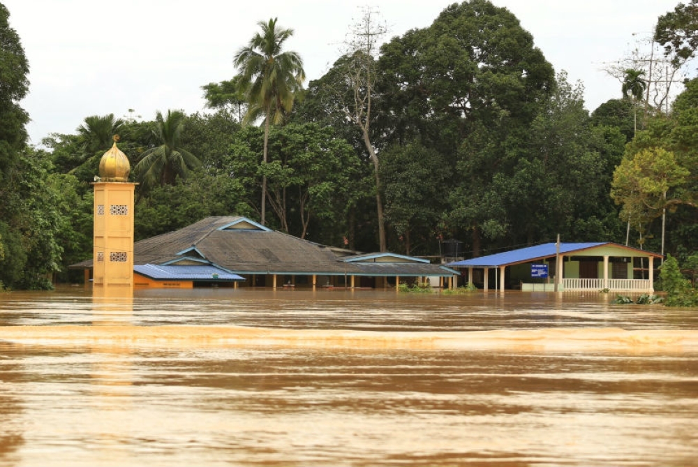 A file photograph from December 2014 shows flood water submerging a mosque near the Pahang river. — Picture by Saw Siow Feng