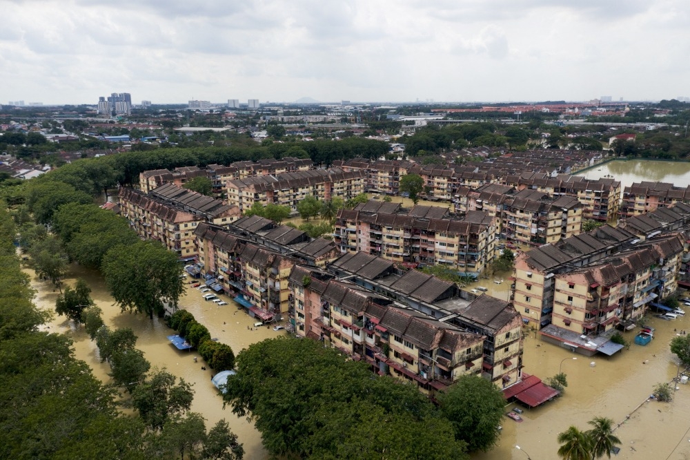 A December 2021 file photograph shows inundated apartment buildings in Taman Sri Muda, Shah Alam. — Reuters pic