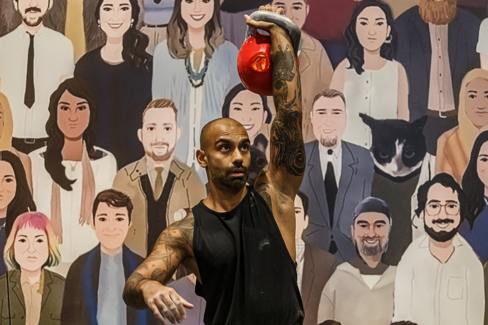 Muk Venkataraman, 44, from Hong Kong snatches a 32kg kettlebell at the tournament. 