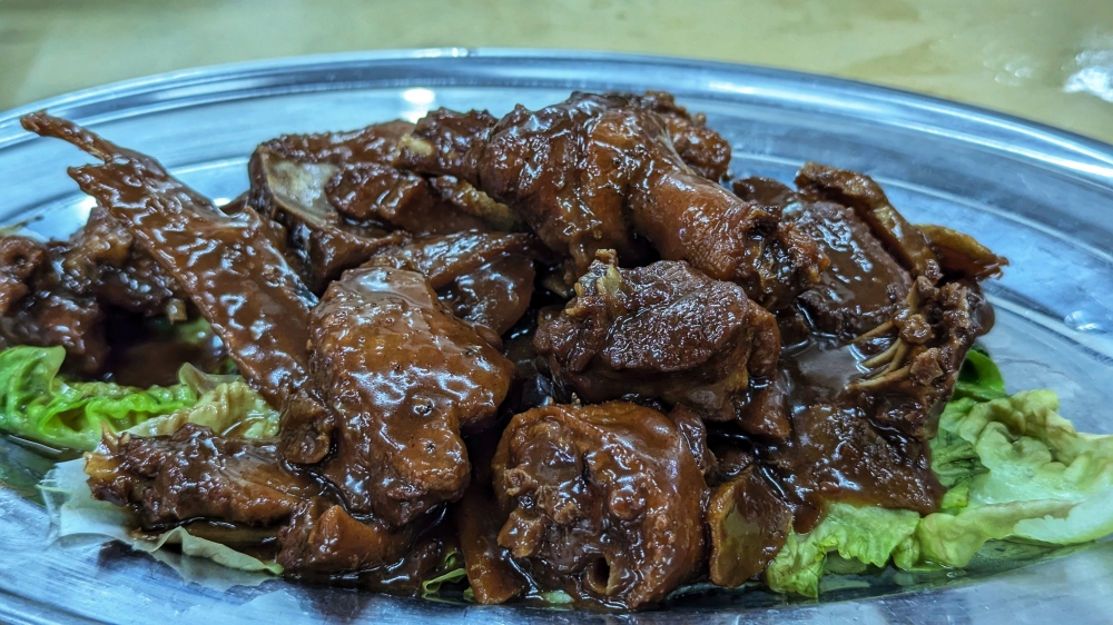 Fork-tender braised duck coated in a luscious, thick sauce. — Picture by Ethan Lau