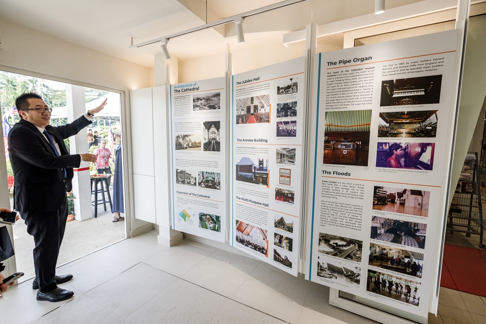 Stanley Lee Wai Jin shows one of the displays in the visitors’ centre, which was St Mary’s Cathedral’s Book Corner for 29 years until it was closed to be converted to the visitors’ space. — Picture by Firdaus Latif