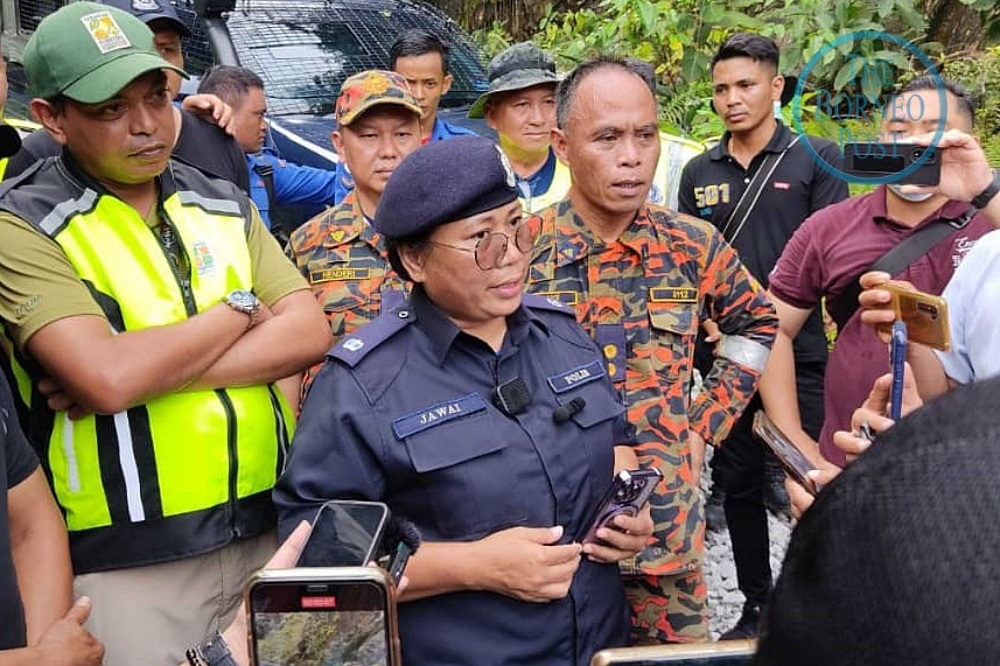 Jawai speaks to reporters while Asraf (left) looks on. — Desiree David/The Borneo Post pic 