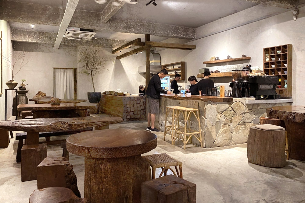 Shan Mu’s interior is a tasteful blend of concrete surfaces and handmade hardwood furniture. — Picture by CK Lim