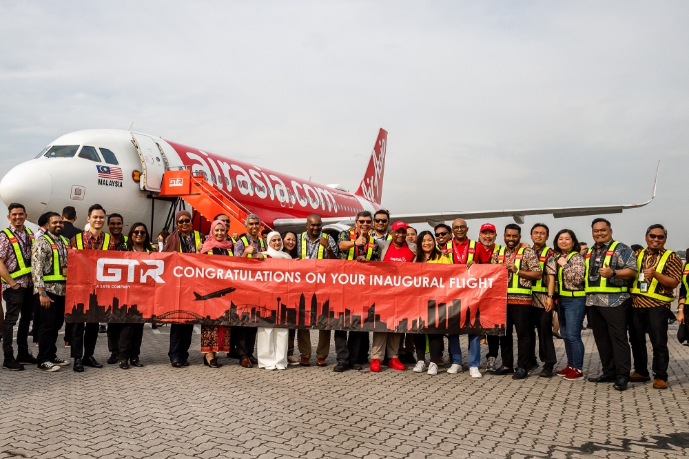 Capital A Bhd and AirAsia personnel celebrate the airline’s inaugural flight to Sultan Abdul Aziz Shah Airport in Subang, on August 30, 2024. — Picture by Firdaus Latif