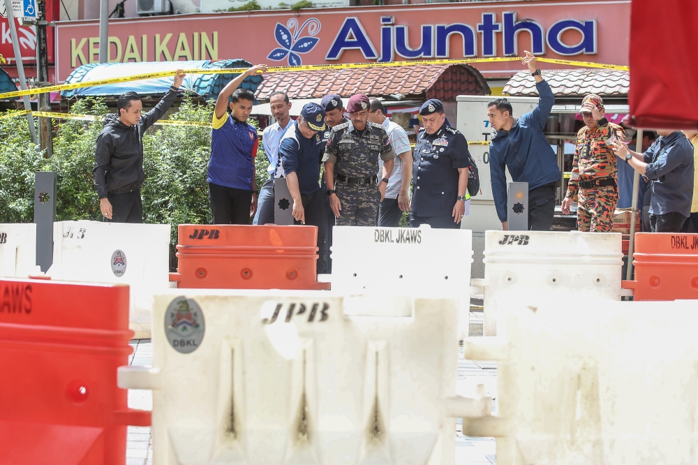 Inspector-General of Police Tan Sri Razarudin Husain visits the site of another sinkhole at Jalan Masjid India about 50 metres from where the first one formed in Kuala Lumpur, August 28, 2024. — Picture by Yusof Mat Isa