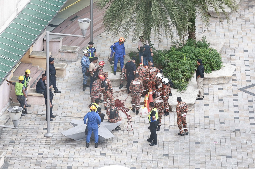 Personnel from the Fire and Rescue Department and other agencies conduct a search and rescue operation at the sinkhole which appeared at Jalan Masjid India, August 25, 2024. — Picture by Sayuti Zainudin