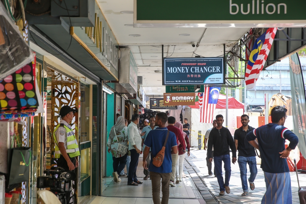 People walking by stores at Jalan Masjid India in Kuala Lumpur September 1, 2024. — Picture by Yusof