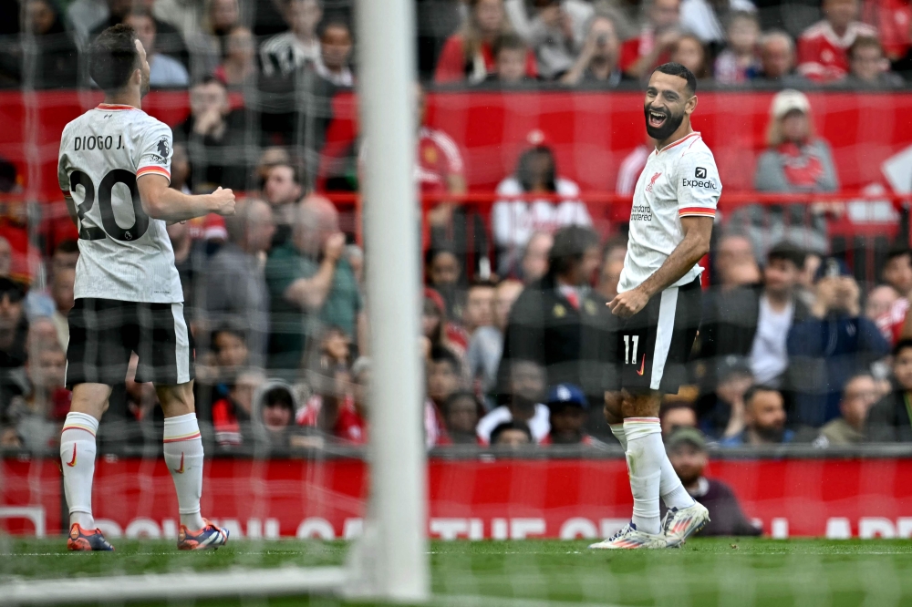 Liverpool's Mohamed Salah (right) celebrates with Diogo Jota after scoring the team's third goal during the English Premier League football match between Manchester United and Liverpool at Old Trafford in Manchester, north west England, on September 1, 2024. — AFP pic