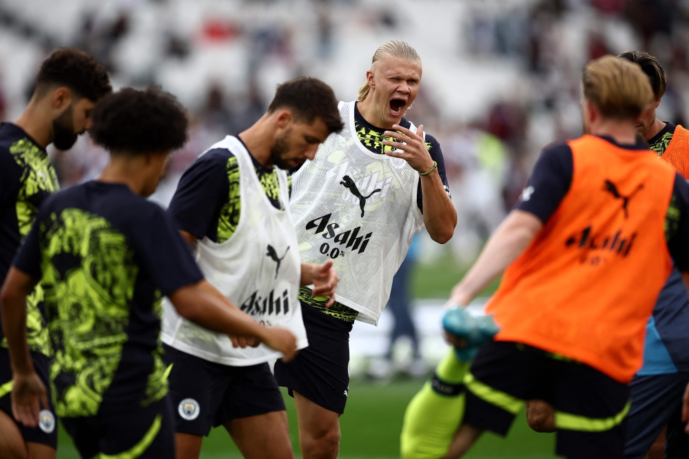 Manchester City's Norwegian striker Erling Haaland yawns as he warms up before the English Premier League football match between West Ham United and Manchester City at the London Stadium, in London on August 31, 2024.— AFP pic