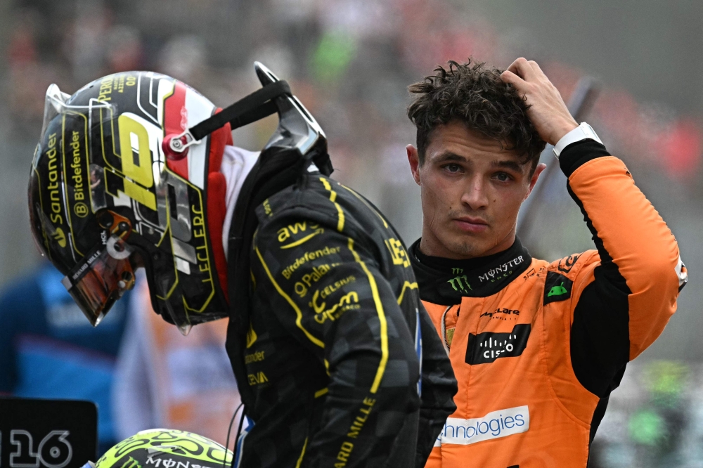 Third placed McLaren's British driver Lando Norris looks on next to winner Ferrari's Monegasque Charles Leclerc (left) after the Italian Formula One Grand Prix race at Autodromo Nazionale Monza circuit, in Monza on September 1, 2024. — AFP pic