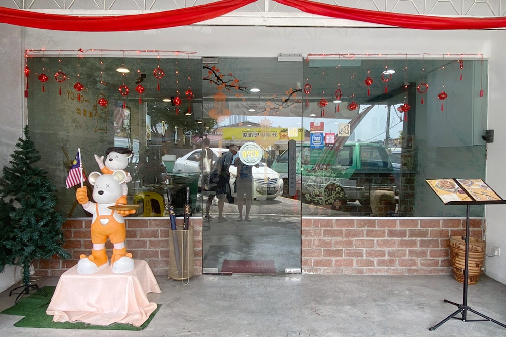 The eclectic entrance to Chaos House Restaurant, with tiny Chinese red lanterns and a Christmas tree. — Picture by CK Lim