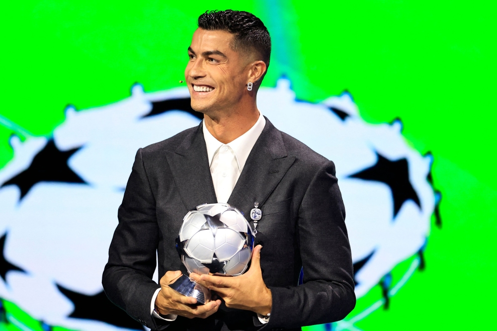 Portugal's national team player and Saudi Al-Nassr's forward Cristiano Ronaldo holds his All-Time Goalscorer Award in the UEFA Champions League. — AFP pic