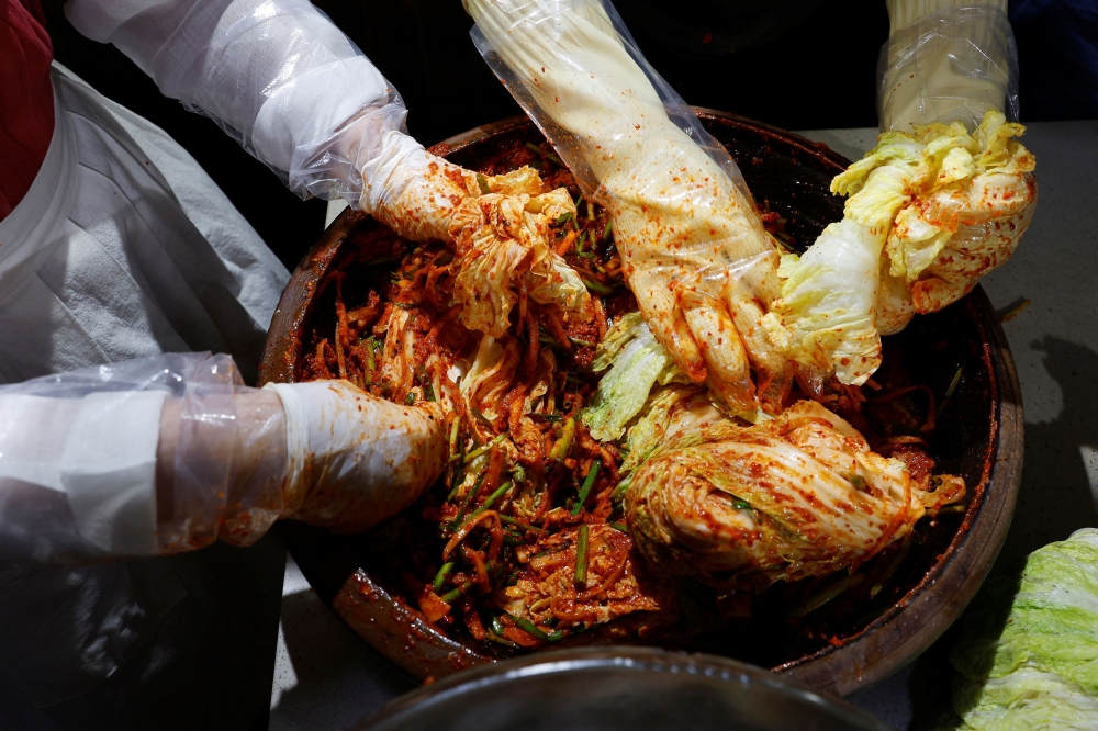 Lee Ha-yeon, a recognized kimchi grand master and her apprentices prepare kimchi at the Kimchi Culture Institute in Namyangju, South Korea, August 21, 2024. — Reuters pic