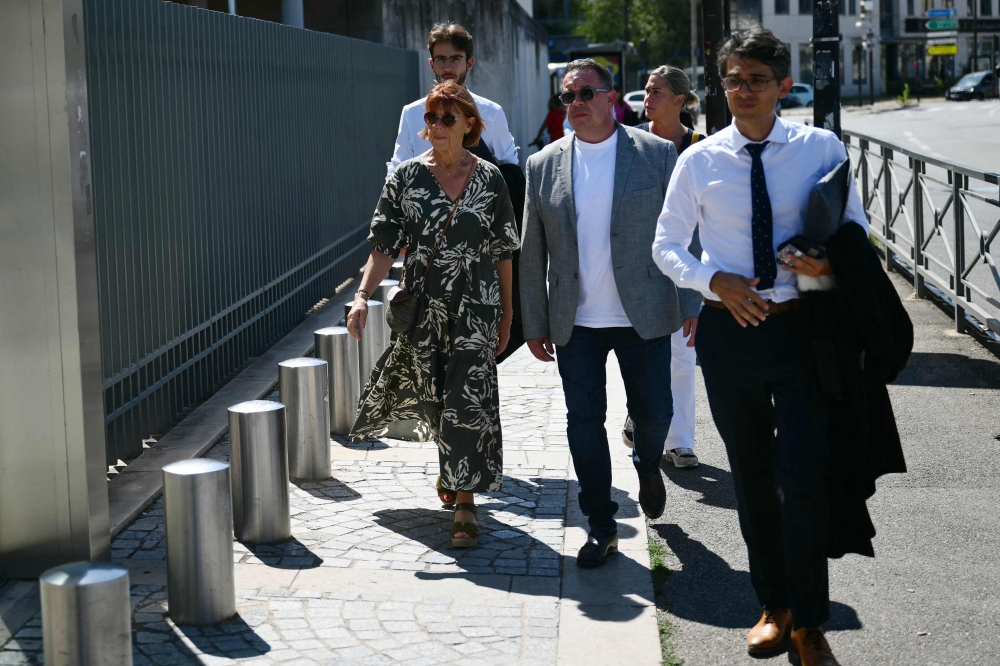 Gisele P. (left) and her son David (centre) arrive to the courthouse during the trial of her husband accused of drugging her for nearly ten years on September 2, 2024. — AFP pic