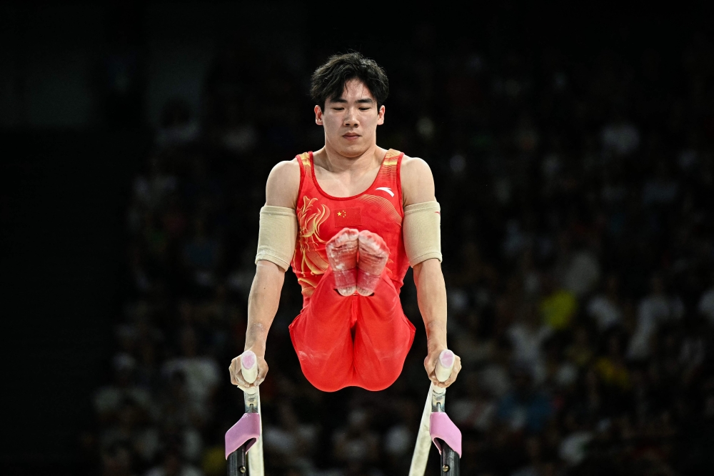 China’s Zhang Boheng competes in the artistic gymnastics men’s parallel bars final during the Paris 2024 Olympic Games at the Bercy Arena in Paris, on August 5, 2024. Crowds descended on the home of 17-year-old Chinese diver Quan Hongchan after she won two golds at the Paris Olympics while gymnast Zhang Boheng hid in a Beijing airport toilet to escape overzealous throngs of fans. — AFP pic 