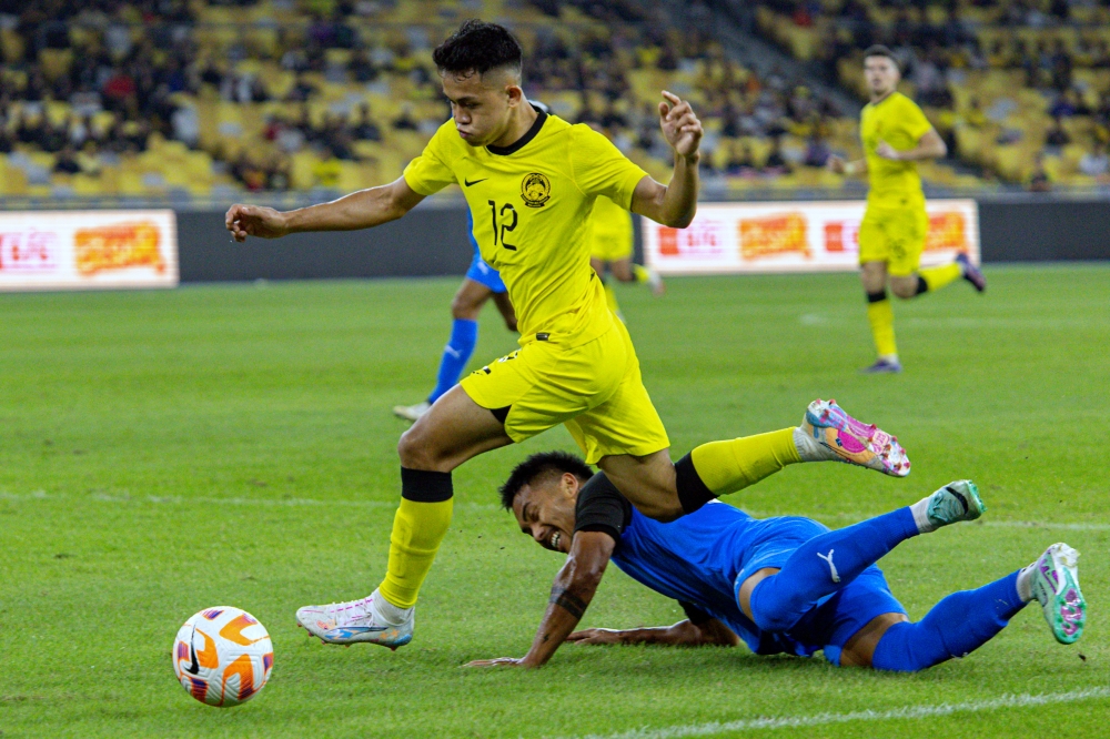 Malaysian player Arif Aiman Mohd Hanapi is challenged by Filipino player Michael Robert Baldisimo during the 2024 Merdeka Tournament semi-final match between Malaysia and the Philippines at the National Stadium Bukit Jalil in Kuala Lumpur September 4, 2024. — Bernama pic