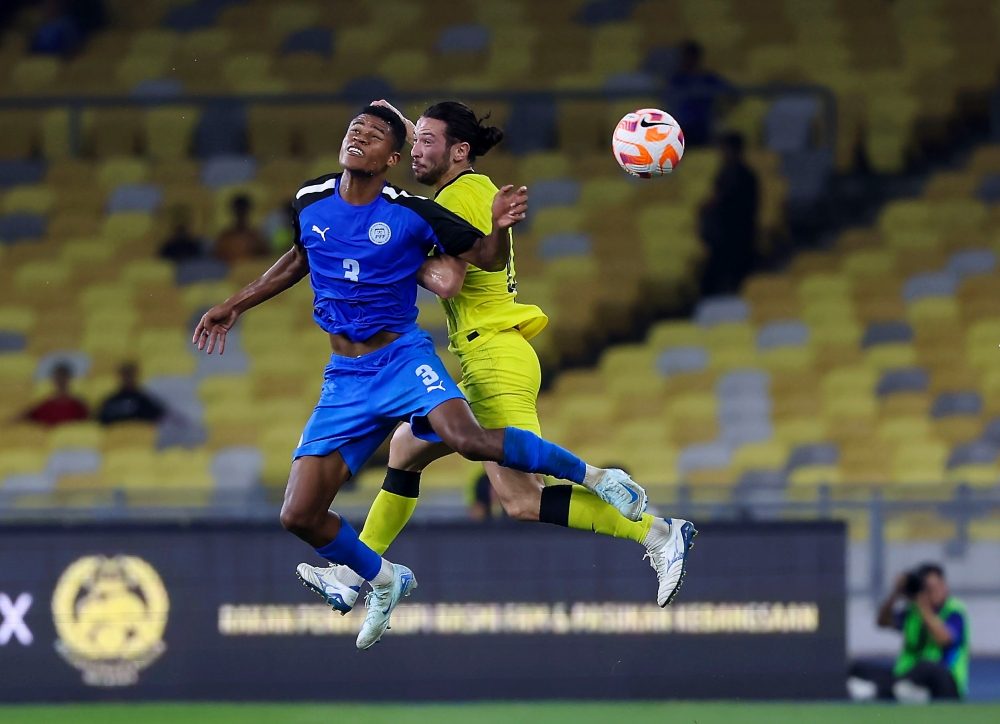 Malaysian player Daniel Ting (right) is challenged by Philippine player Paul Bismarck Tabinas (left) during the Merdeka Tournament 2024 semi-final match between Malaysia and the Philippines at the National Stadium Bukit Jalil in Kuala Lumpur September 4, 2024. — Bernama pic