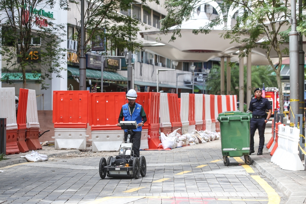 Representative from the Department of Mineral and Geoscience Malaysia is seen wheeling a ground penetrating radar (GPR) device at the Jalan Masjid India in Kuala Lumpur August 28, 2024. — Picture by Yusof Mat Isa