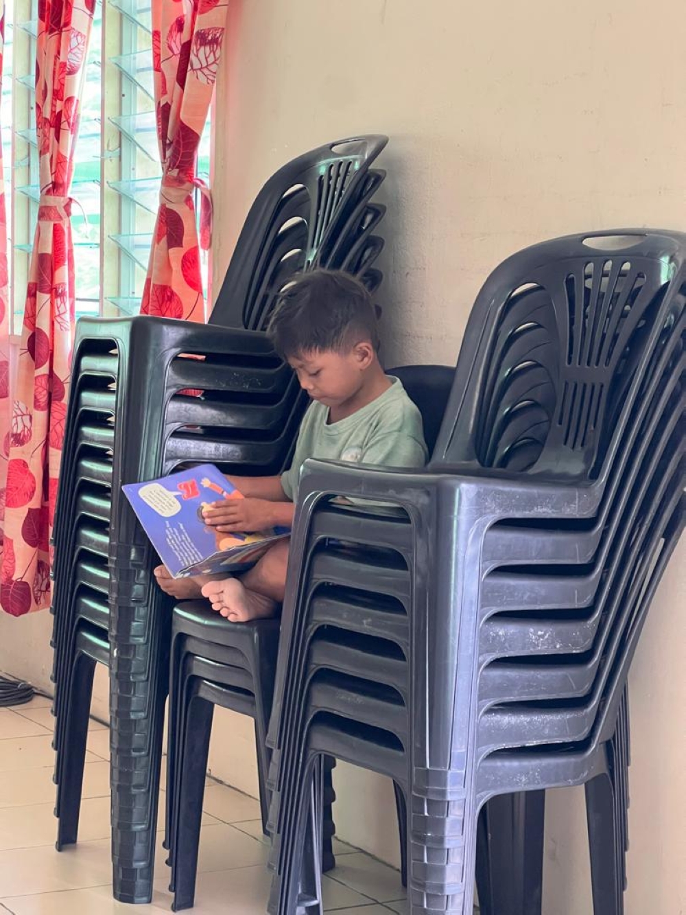 A little boy flipping through the pages.