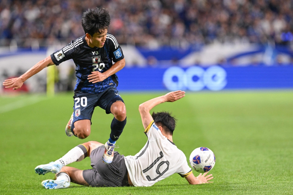 Japan’s midfielder Takefusa Kubo (left) clashes with China’s defender Liu Yang during the third round 2026 World Cup qualifying round football match between Japan and China at Saitama Stadium in Saitama, north of Tokyo, on September 5, 2024. — AFP