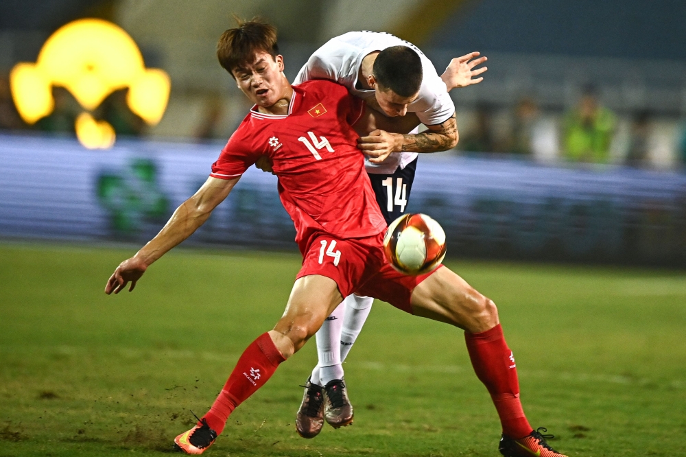 Vietnam’s Nguyen Hoang Duc (left) fights for the ball with Russia’s Yevgeny Morozov during the international friendly football match between Vietnam and Russia at My Dinh National Stadium in Hanoi on September 5, 2024.  — AFP