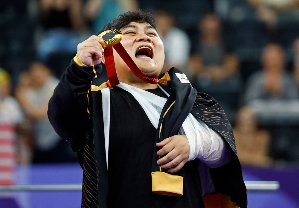 Gold medallist Bonnie Bunyau Gustin of Malaysia reacts during medal ceremony at Porte de La Chapelle Arena, Paris, September 6, 2024. — Reuters pic 