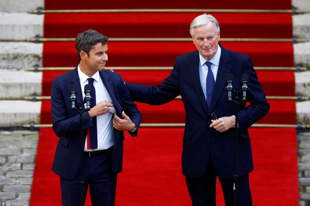 Outgoing France's Prime Minister Gabriel Attal (left) and newly appointed Prime Minister Michel Barnier attend the handover ceremony at the Hotel Matignon in Paris on September 5, 2024. — AFP pic