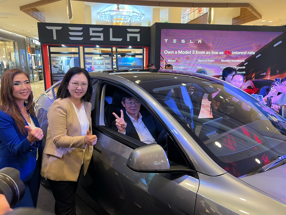 Penang Chief Minister Chow Kon Yeow tries out Tesla’s Model Y at the roadshow in Gurney Plaza. — Picture by Opalyn Mok