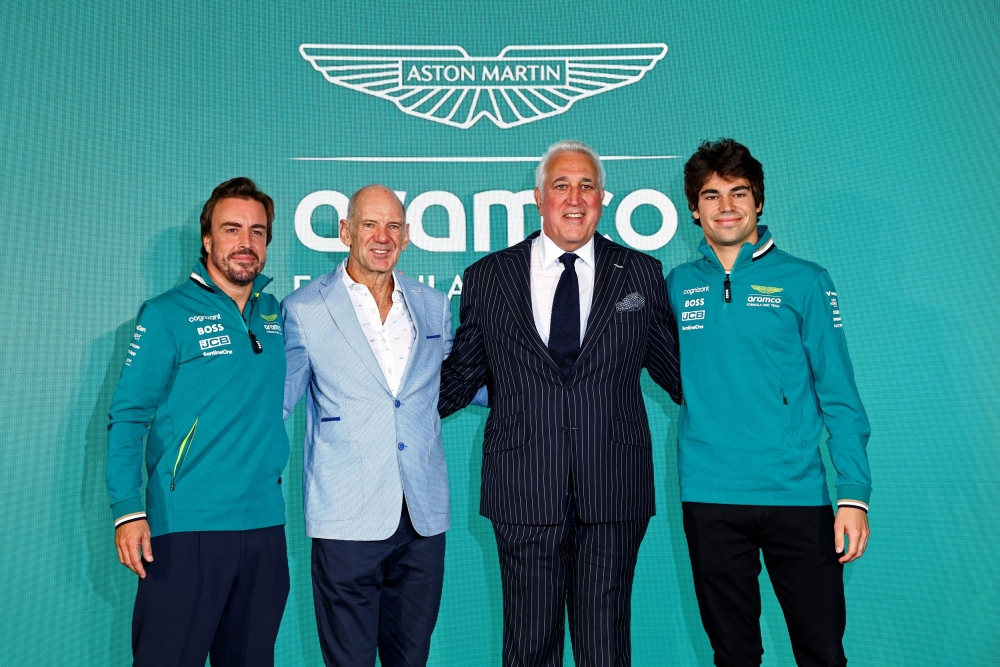 Aston Martin chairperson Lawrence Stroll (2nd right) with drivers Lance Stroll (right) and Fernando Alonso (left), and new managing technical partner Adrian Newey after the press conference. — Reuters pic