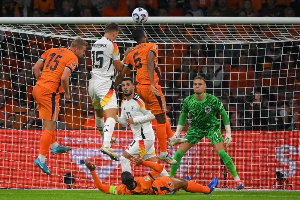 Germany's defender Nico Schlotterbeck (centre) heads the ball during the UEFA Nations League football match between Netherlands and Germany at the Johan Cruyff Arena in Amsterdam, on September 10, 2024. — AFP pic